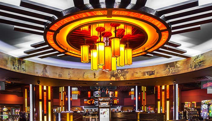 Low lights and vivid slot machine displays enhance attraction to the gaming environment.